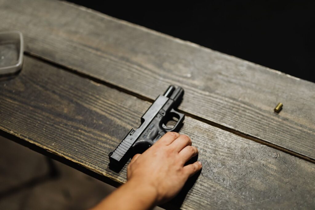 Glock pistol resting on a wooden shooting bench
